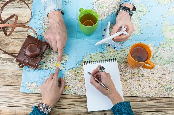 Du khách sử dụng bản đồ hoặc điện thoại để định hướng khi du lịch châu Á
